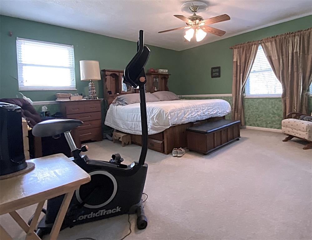 626 Orchid Lane Altamonte Springs, FL 32714 - Photo 10 of 24 a bedroom with a bed and a chandelier