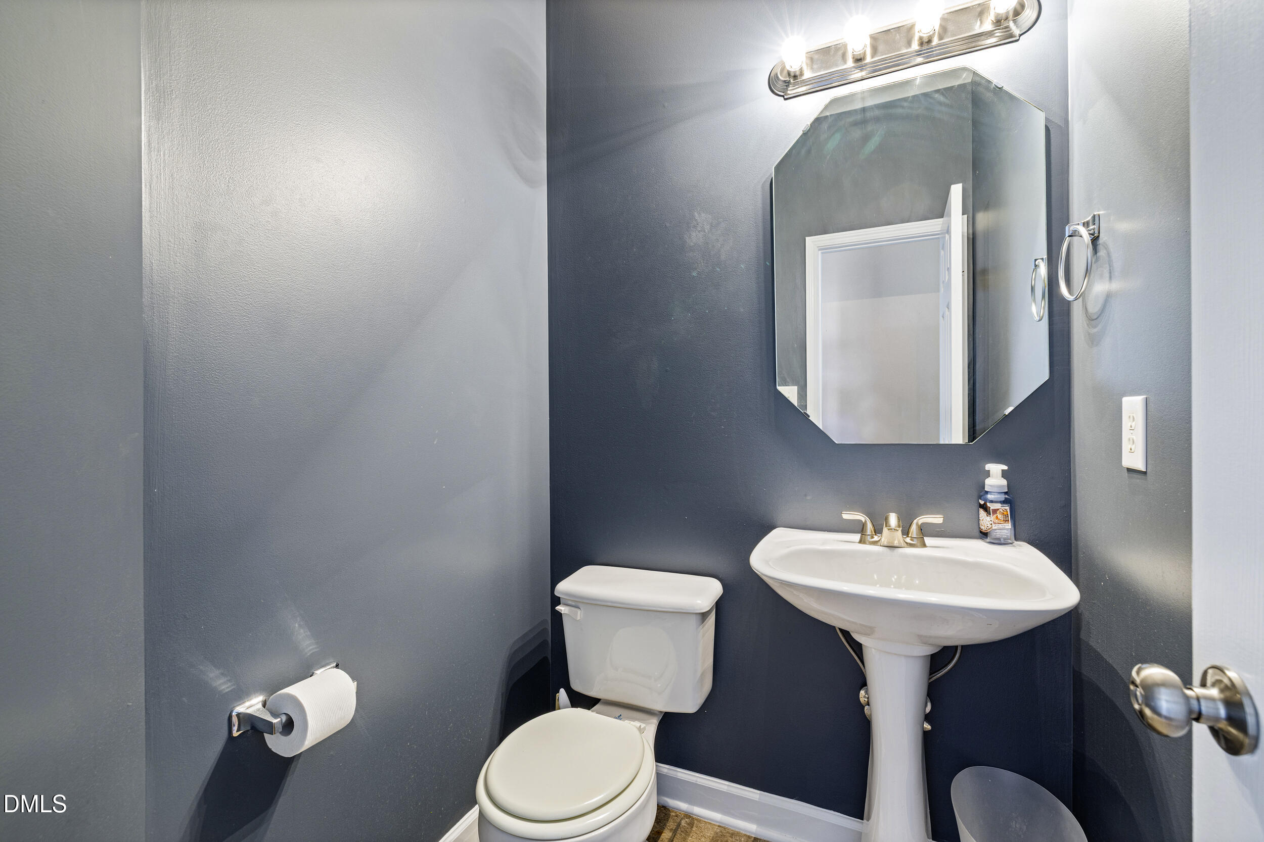 2208 Water Spray Drive Raleigh, NC 27610 - Photo 12 of 28 a bathroom with a toilet sink and mirror