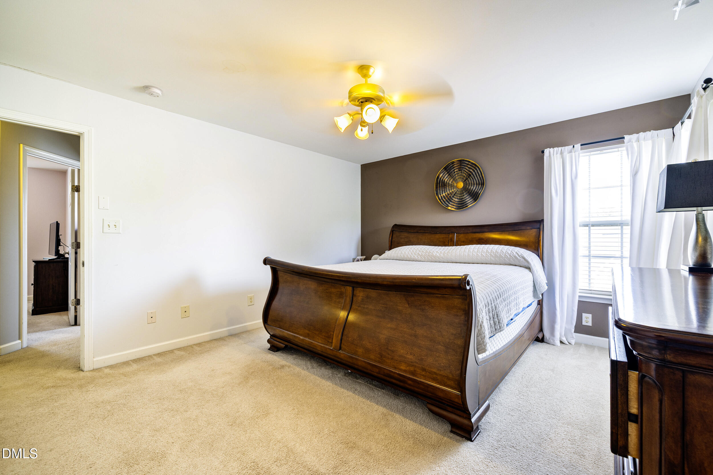 2208 Water Spray Drive Raleigh, NC 27610 - Photo 17 of 28 a bedroom with a bed and a painting on the wall