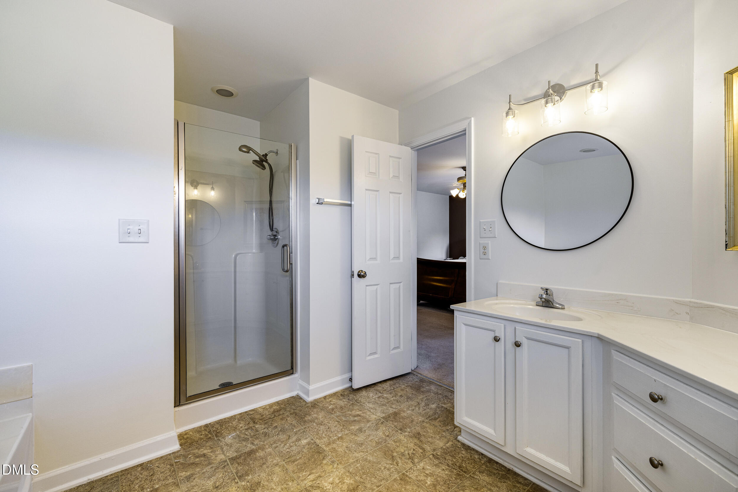 2208 Water Spray Drive Raleigh, NC 27610 - Photo 20 of 28 a bathroom with a sink and a mirror