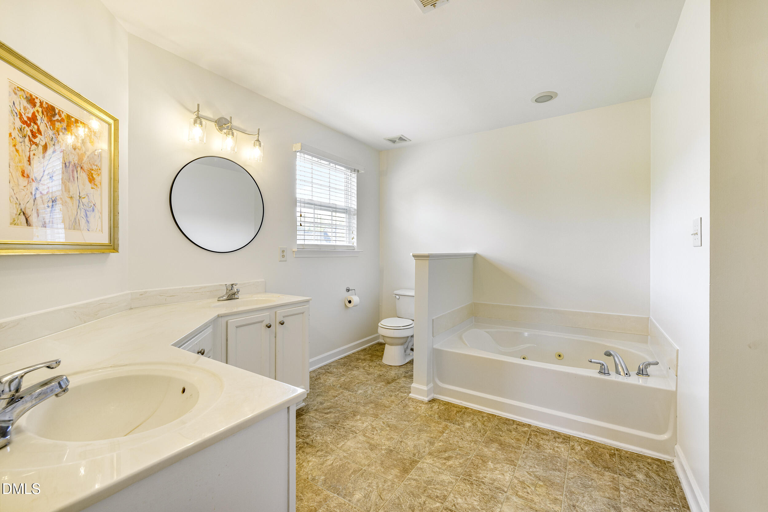 2208 Water Spray Drive Raleigh, NC 27610 - Photo 21 of 28 a bathroom with a tub sink and mirror