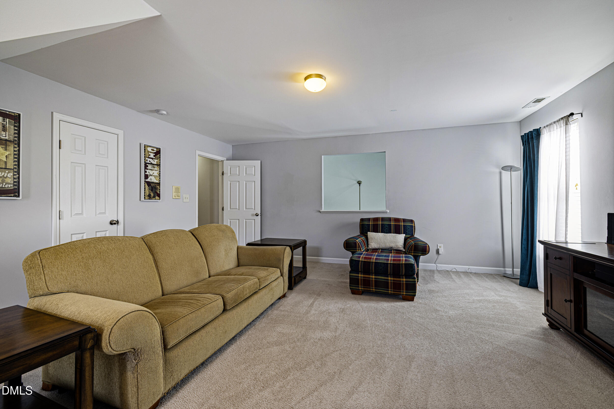 2208 Water Spray Drive Raleigh, NC 27610 - Photo 24 of 28 a living room with furniture and a flat screen tv