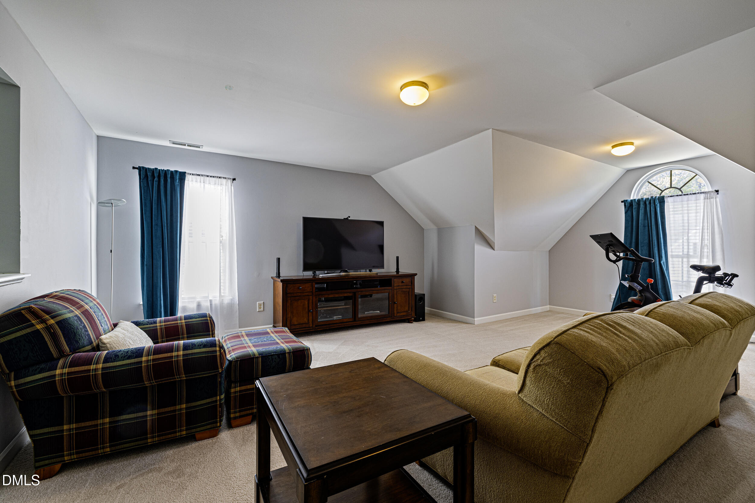 2208 Water Spray Drive Raleigh, NC 27610 - Photo 25 of 28 a living room with furniture a flat screen tv and kitchen view