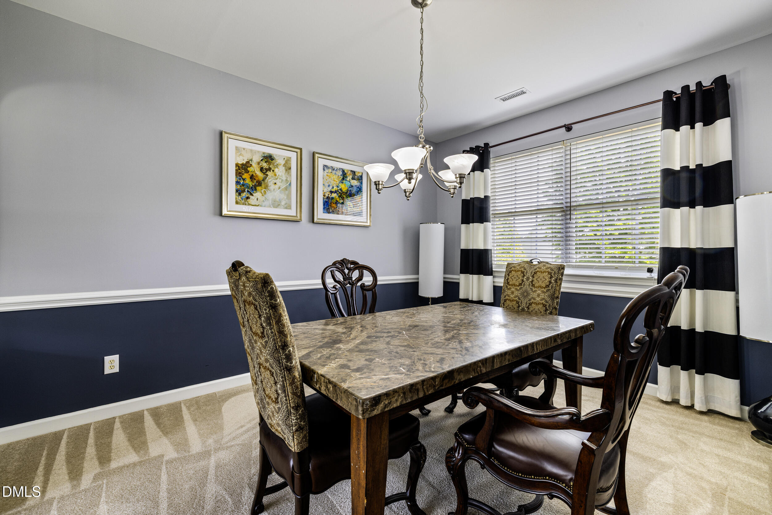 2208 Water Spray Drive Raleigh, NC 27610 - Photo 8 of 28 a view of a dining room with a table and chairs
