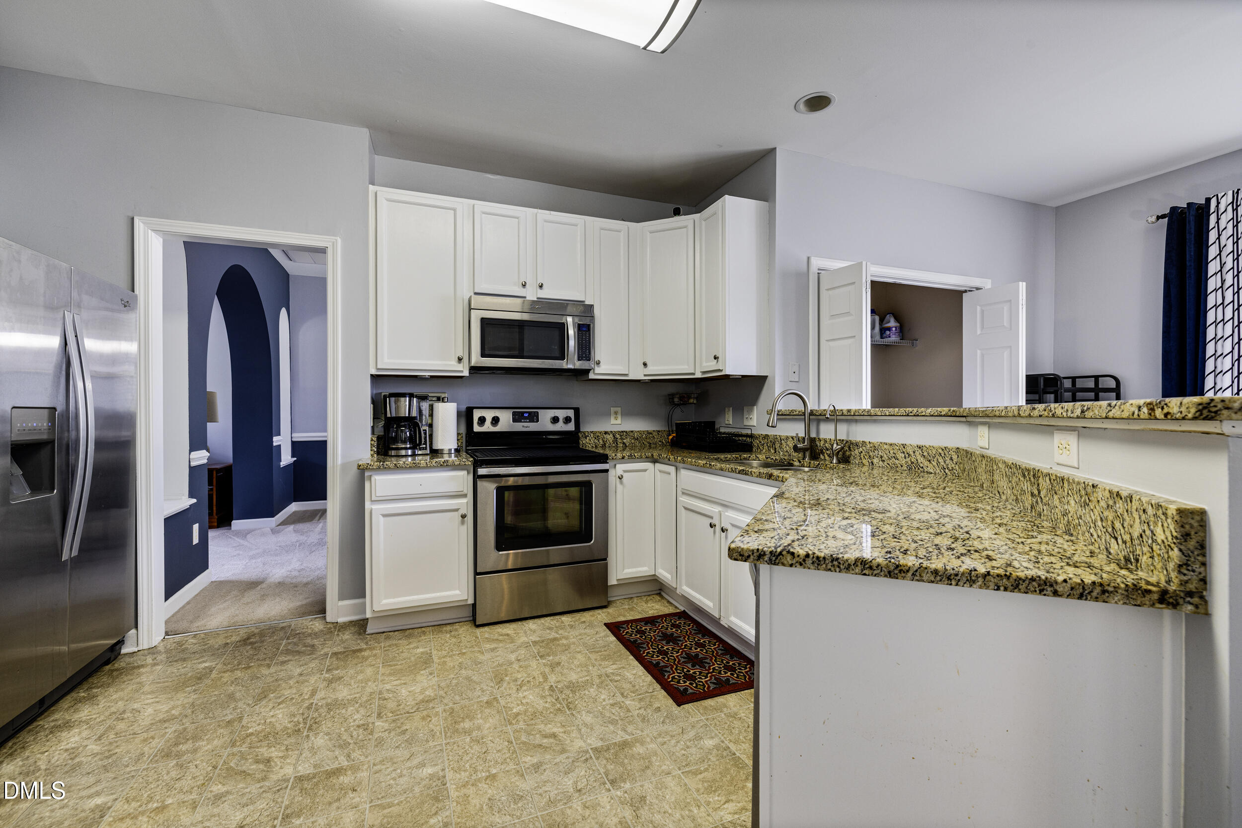 2208 Water Spray Drive Raleigh, NC 27610 - Photo 9 of 28 a kitchen with stainless steel appliances granite countertop a sink stove and refrigerator