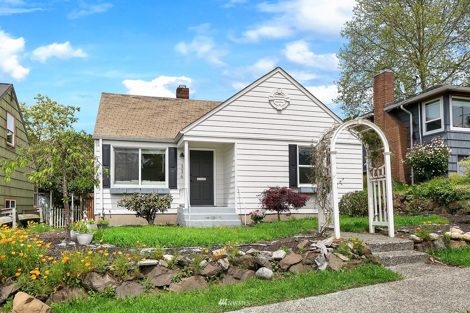 336 Northwest 47th Street Seattle, WA 98107 - Photo 1 of 36 a front view of a house with garden