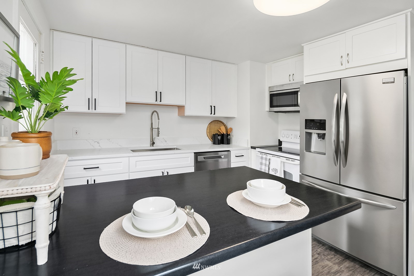 336 Northwest 47th Street Seattle, WA 98107 - Photo 11 of 36 a kitchen with a sink refrigerator and stove