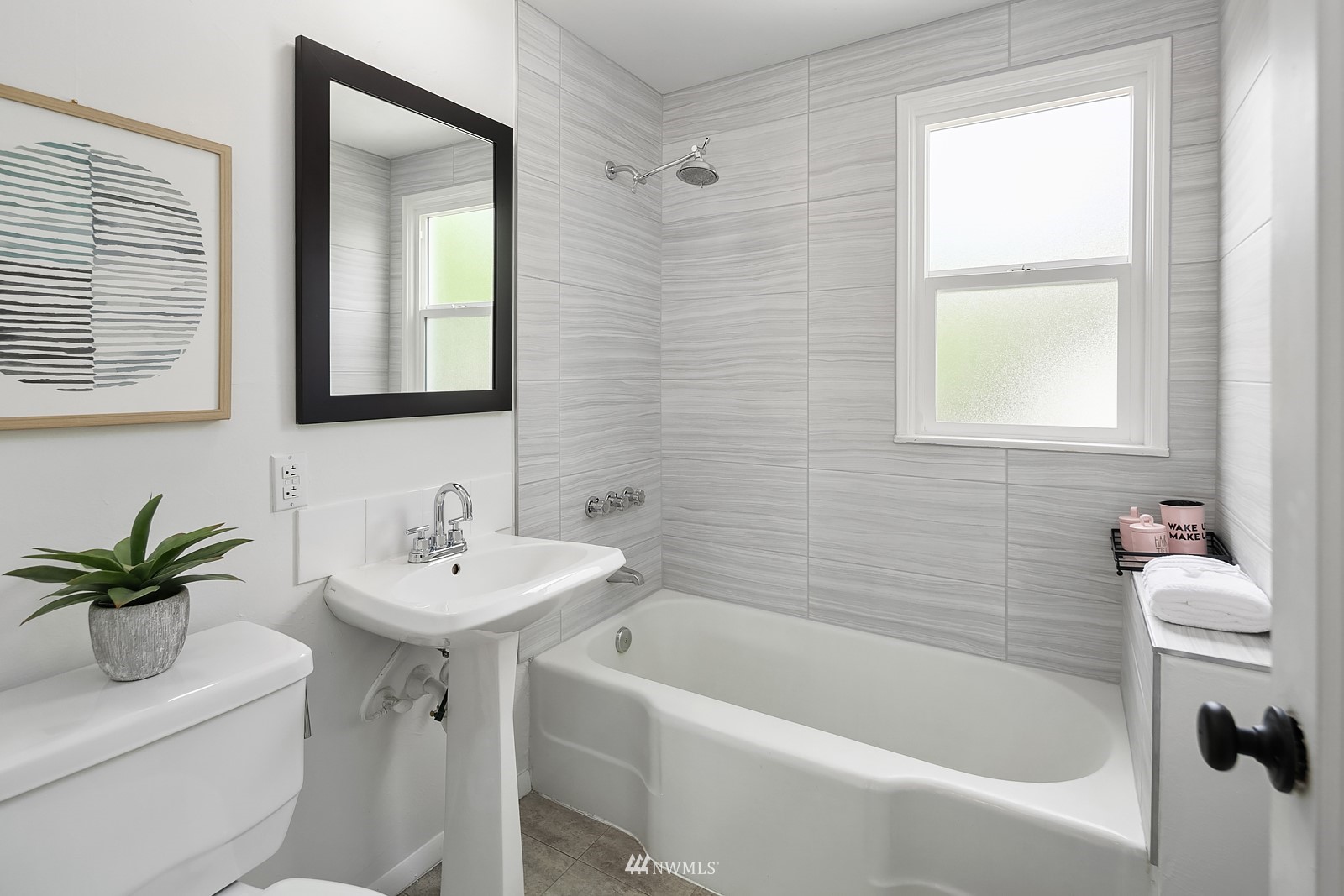 336 Northwest 47th Street Seattle, WA 98107 - Photo 15 of 36 a white bath tub sitting next to a white sink and a mirror