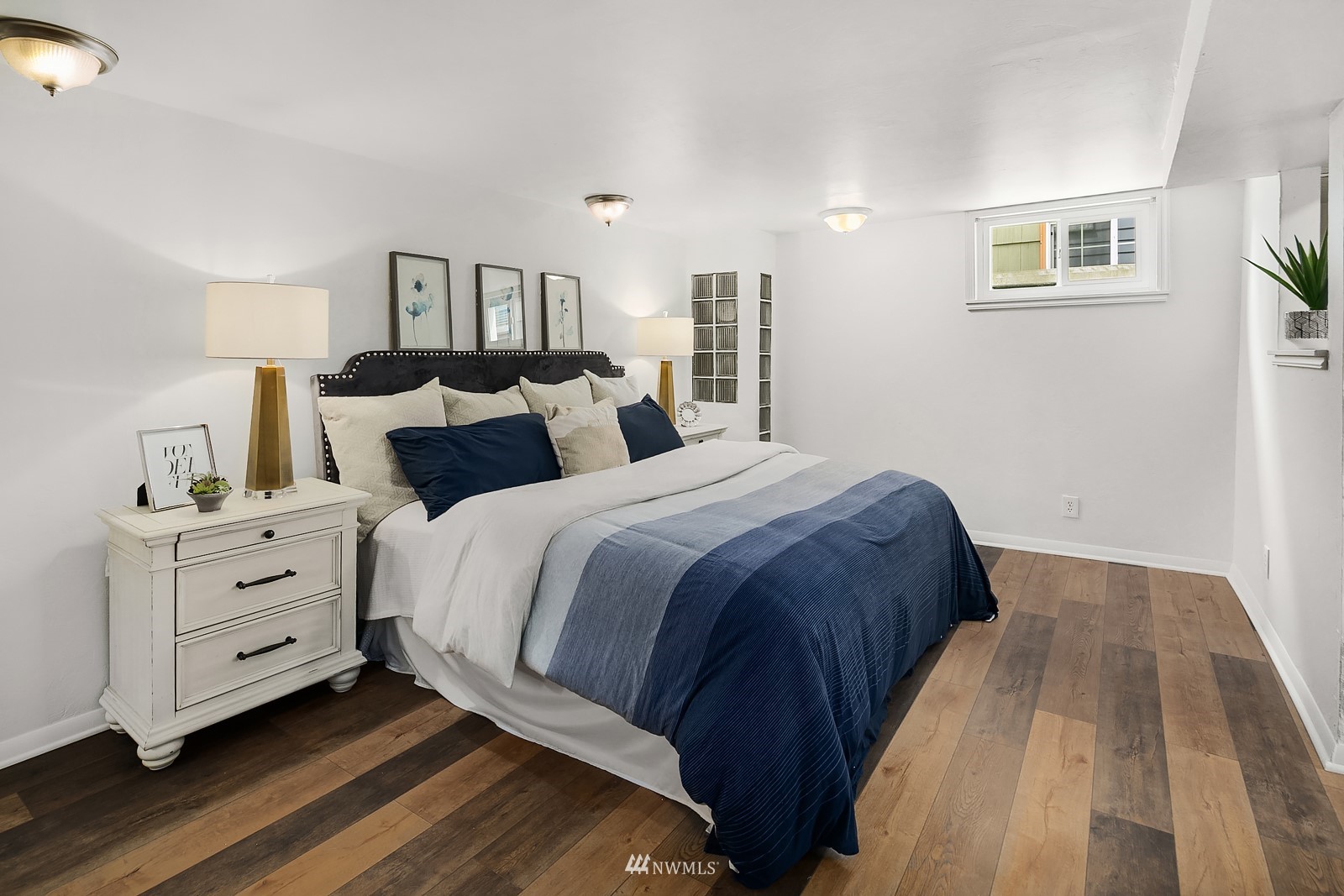 336 Northwest 47th Street Seattle, WA 98107 - Photo 16 of 36 a bedroom with double bed and a night stand