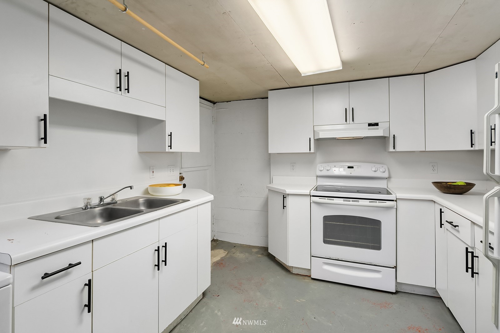 336 Northwest 47th Street Seattle, WA 98107 - Photo 22 of 36 a kitchen with cabinets stainless steel appliances a sink and dishwasher