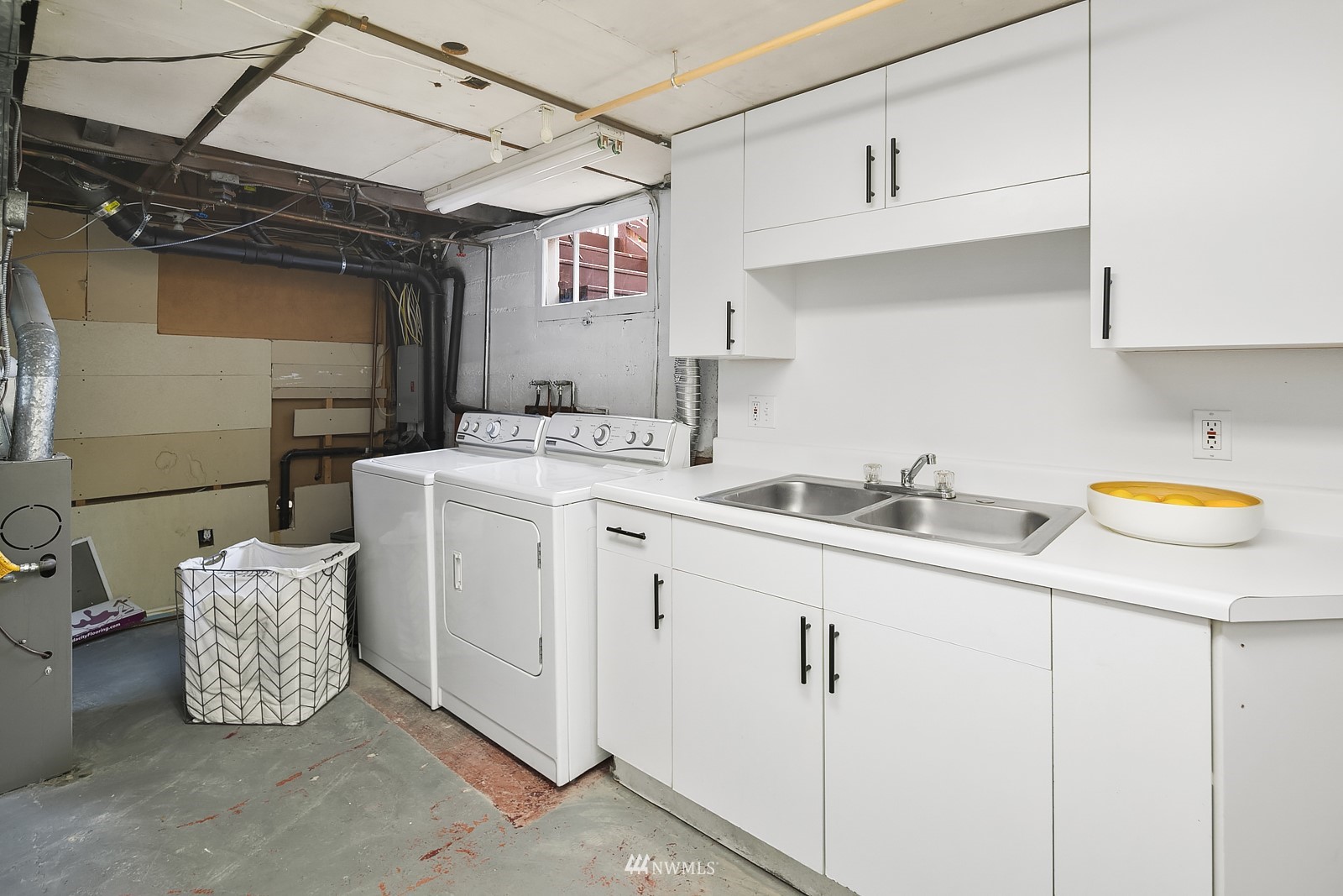336 Northwest 47th Street Seattle, WA 98107 - Photo 23 of 36 a utility room with cabinets washer and dryer