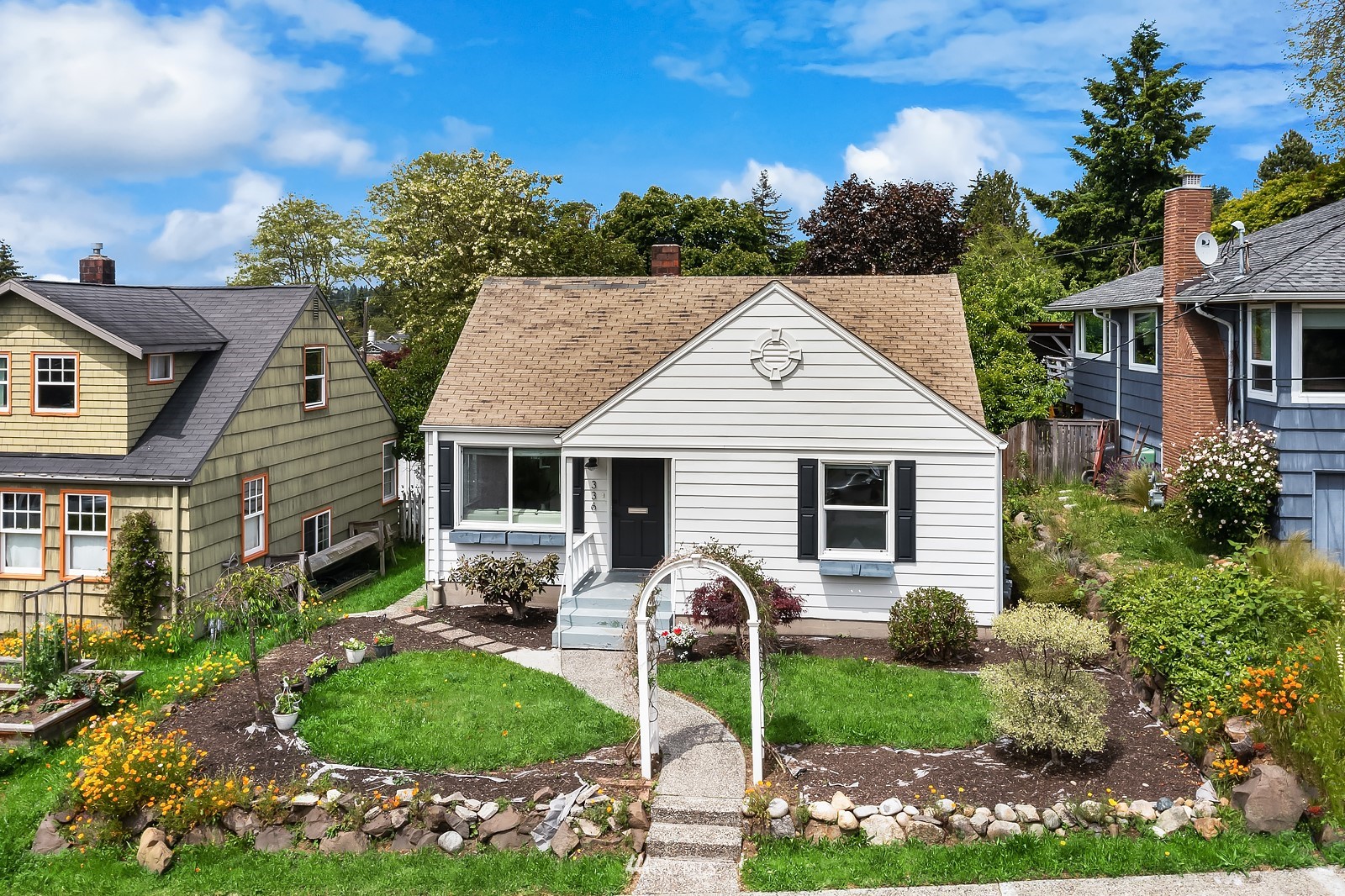 336 Northwest 47th Street Seattle, WA 98107 - Photo 32 of 36 a view of a house with backyard sitting area and garden