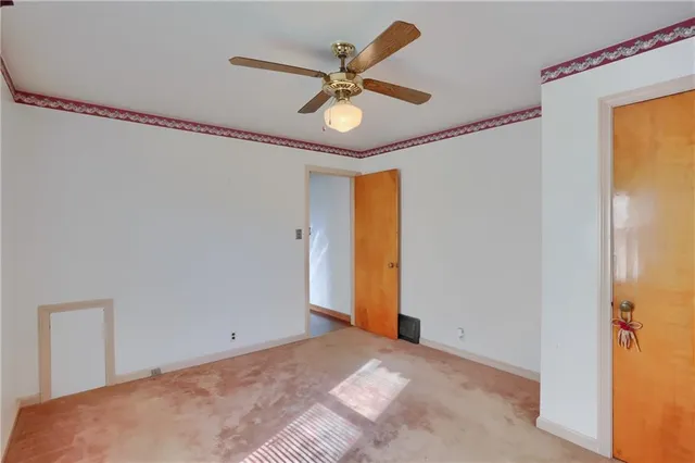 a view of a livingroom with a ceiling fan and a window