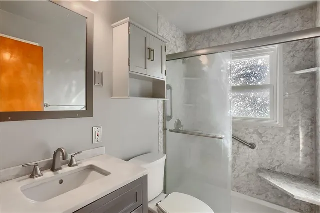 a bathroom with a sink toilet and shower