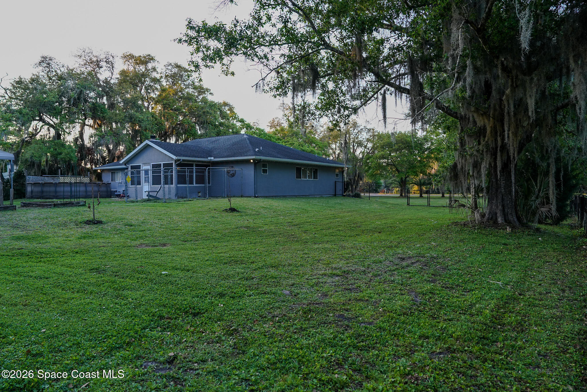 1265 Pine Island Road Merritt Island, FL 32953 - Photo 18 of 20 a view of a yard in front of a house with large trees