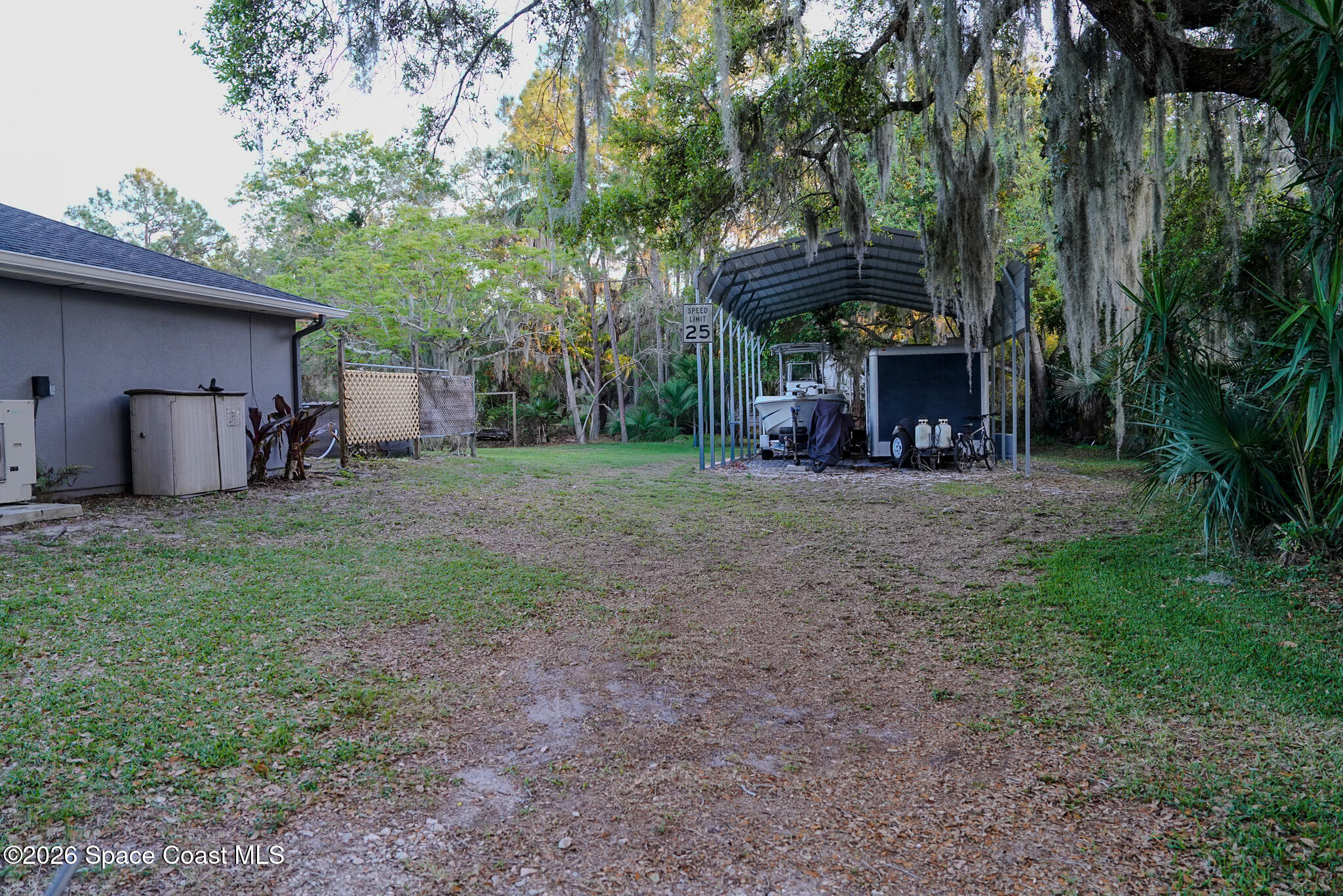 1265 Pine Island Road Merritt Island, FL 32953 - Photo 19 of 20 a view of a house with a yard and tree