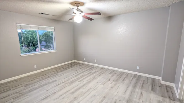 wooden floor in an empty room with a window