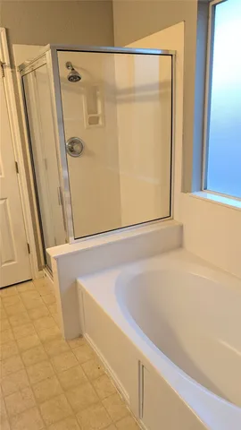 a bathroom with a shower and a tub