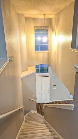 a view of a room with wooden floor and windows