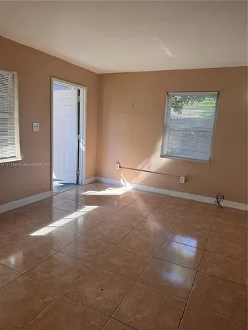 a view of a livingroom with an empty space and window