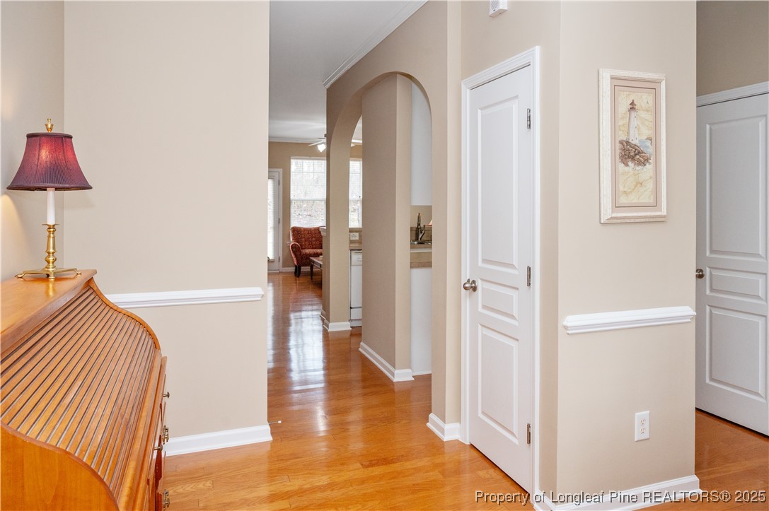 5229 Moonview Court Raleigh, NC 27606 - Photo 11 of 38 a view of a hallway with wooden floor and staircase
