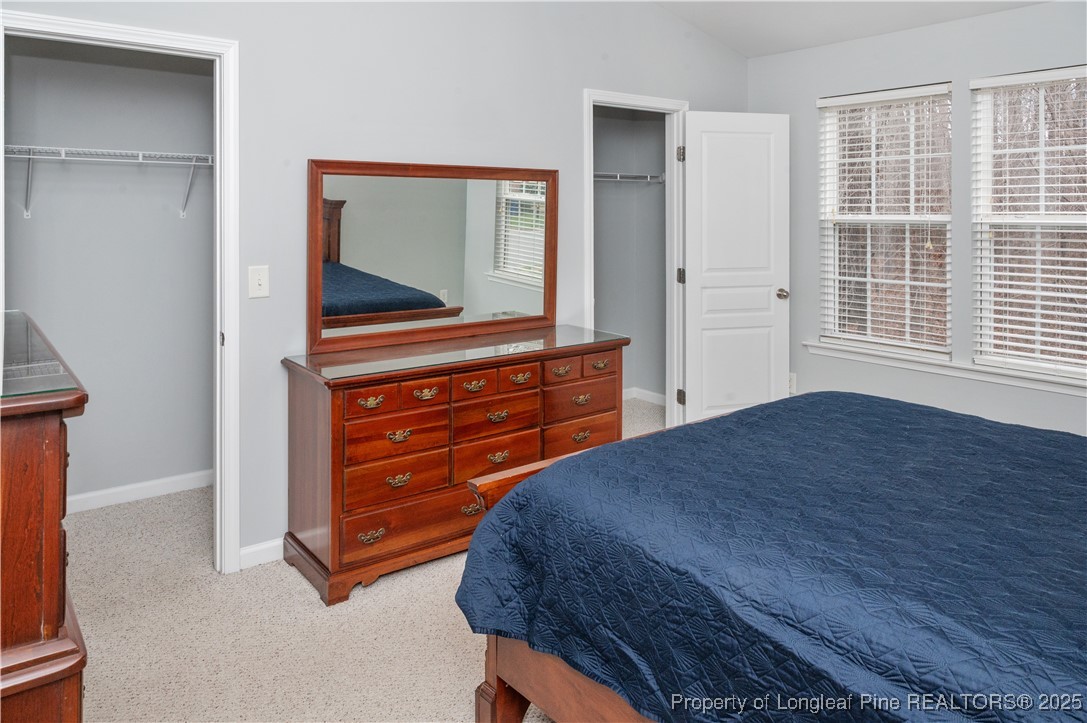 5229 Moonview Court Raleigh, NC 27606 - Photo 20 of 38 a bedroom with a bed and a dresser