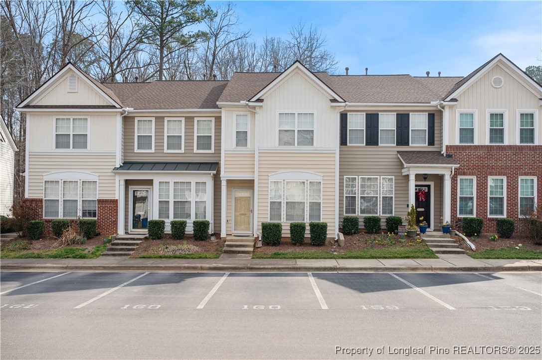 5229 Moonview Court Raleigh, NC 27606 - Photo 2 of 38 a front view of a residential apartment building with a yard