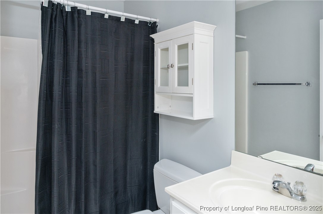 5229 Moonview Court Raleigh, NC 27606 - Photo 21 of 38 a bathroom with a sink toilet and shower