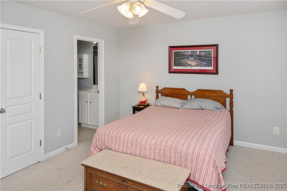 5229 Moonview Court Raleigh, NC 27606 - Photo 27 of 38 a bedroom with a bed and a painting on the wall