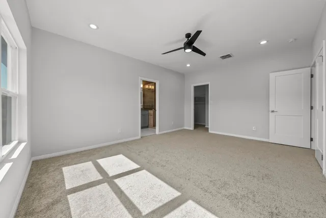 a view of a livingroom with furniture and a ceiling fan
