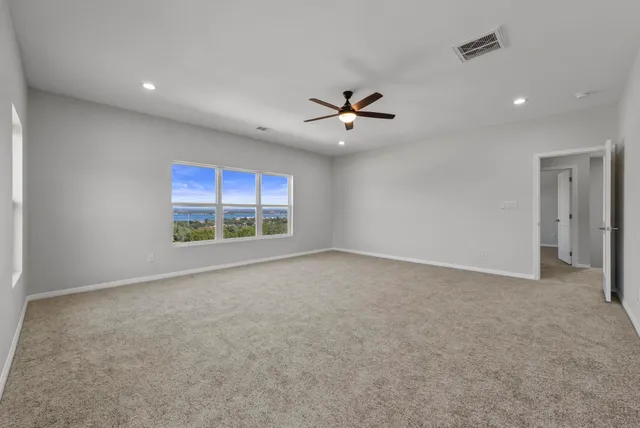 a bathroom with a granite countertop sink a toilet and shower