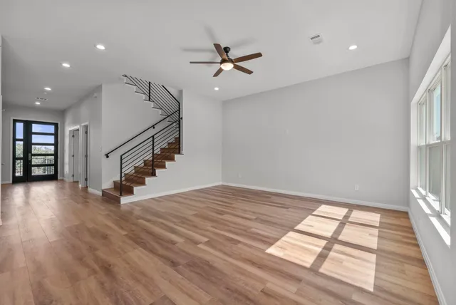 wooden floor in an empty room with a window
