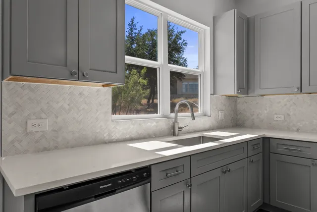 a kitchen with a sink and cabinets
