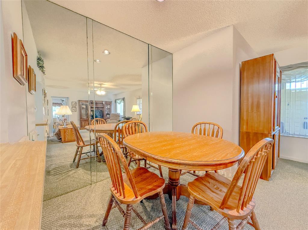 329 Knotty Pine Circle, Unit C2 Greenacres, FL 33463 - Photo 19 of 39 a patio with a table and chairs