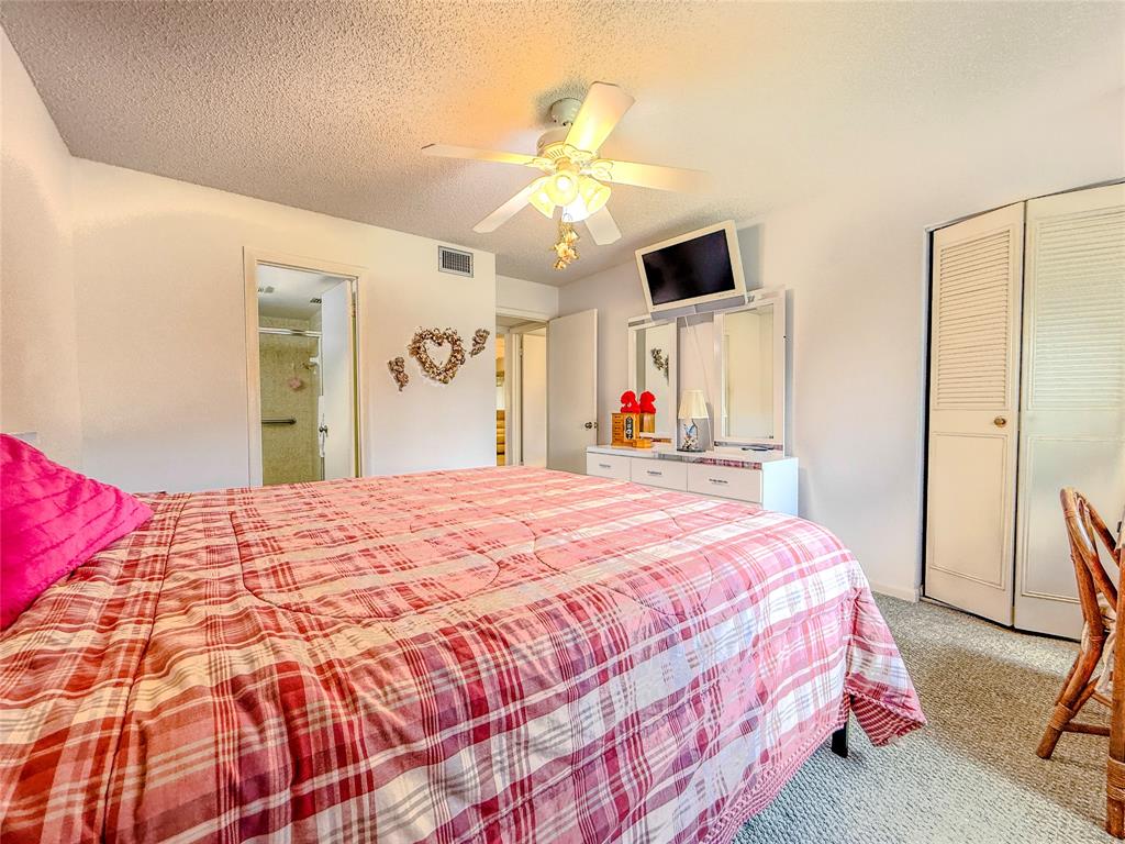 329 Knotty Pine Circle, Unit C2 Greenacres, FL 33463 - Photo 21 of 39 a bedroom with a bed and a flat screen tv