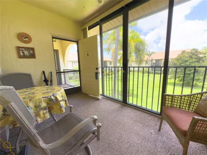 a bedroom with a bed and dresser with chair