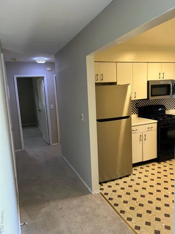 a kitchen with a refrigerator and a stove