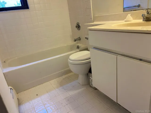 a bathroom with a toilet and a bath tub