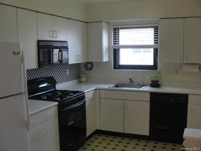 a kitchen with stainless steel appliances a sink stove and cabinets