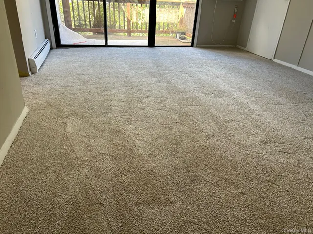 a view of empty room with floor to ceiling window