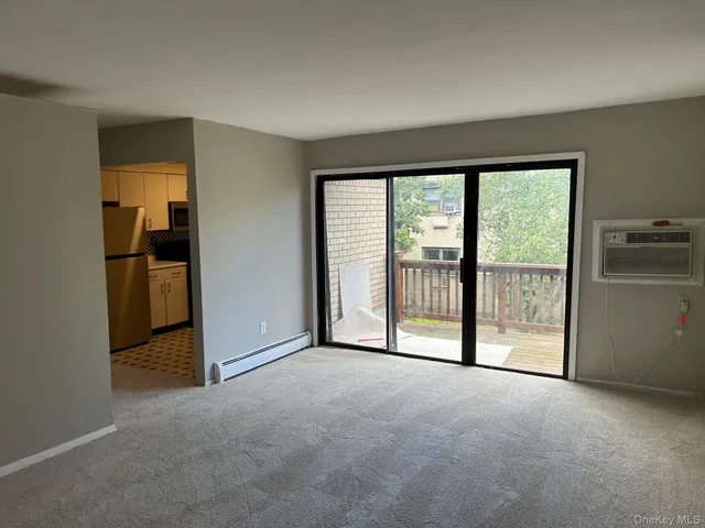 a view of a big room with wooden floor and door