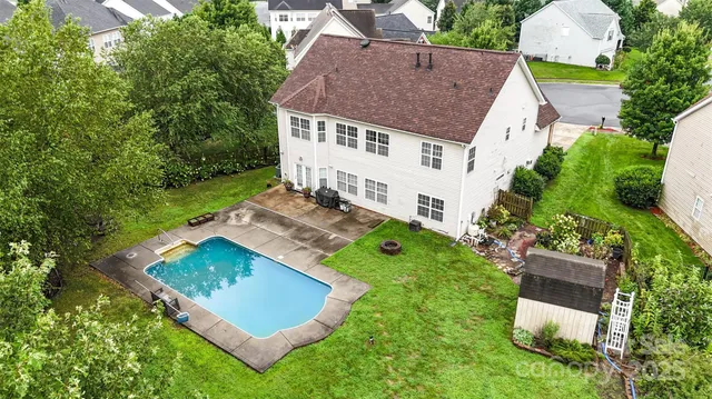 a view of a lake with couches and wooden fence