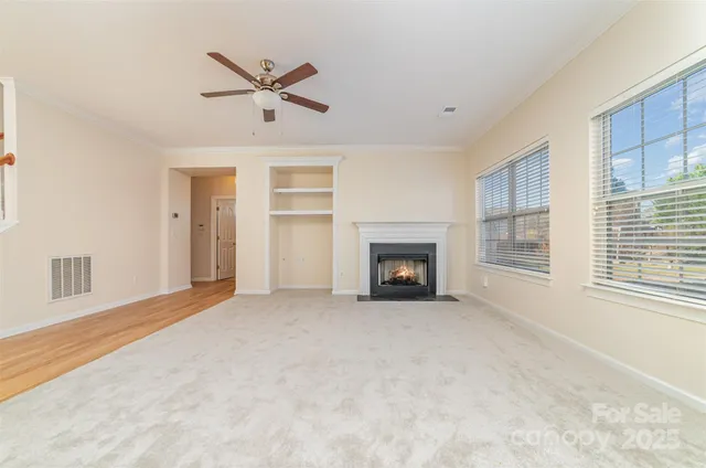 a view of an empty room with a fireplace