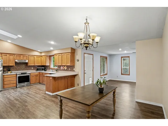 a living room with kitchen island furniture and a chandelier