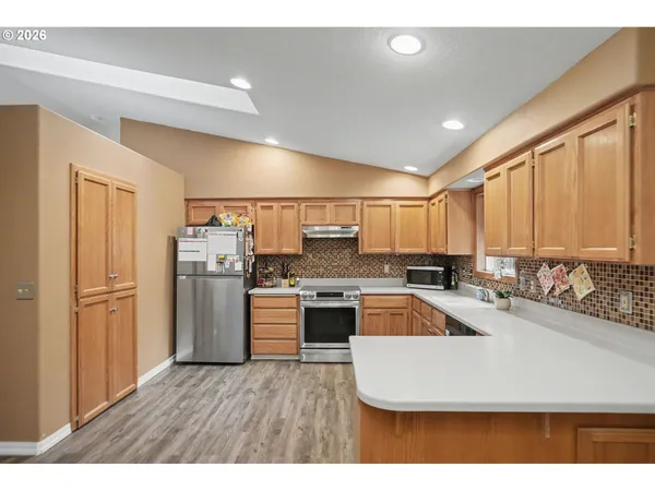 a kitchen with refrigerator and cabinets