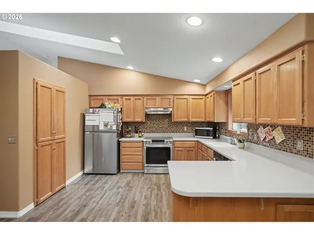 a kitchen with refrigerator and cabinets
