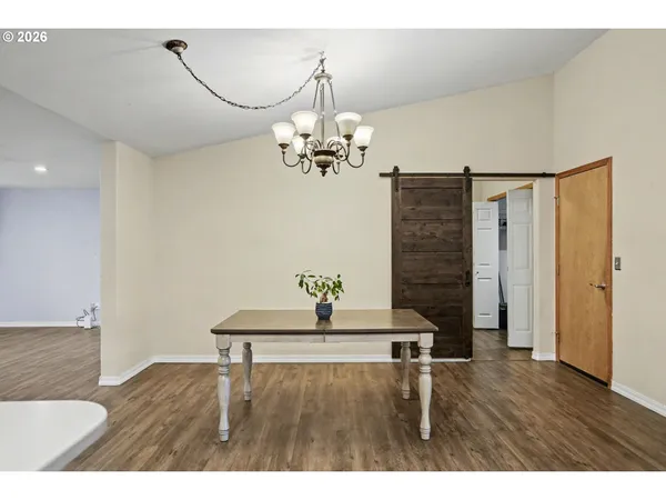 a view of a room with wooden floor and windows