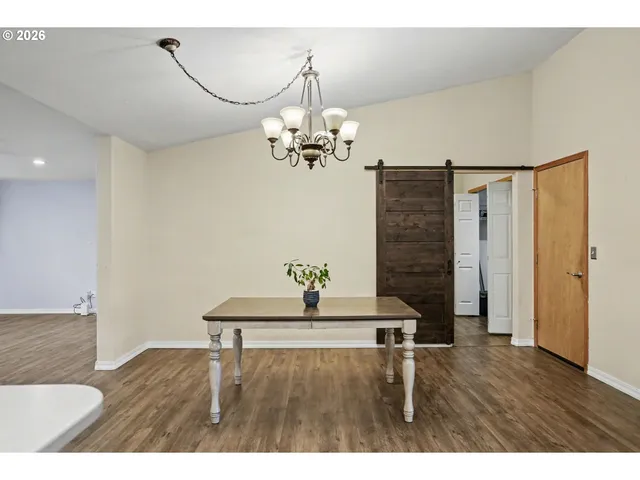 a view of a room with wooden floor and windows