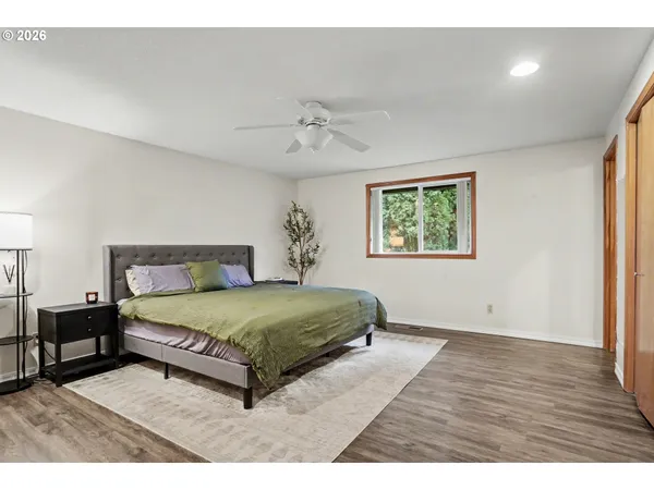 a bedroom with a large bed and a window
