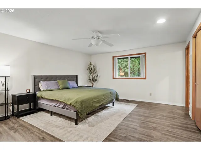 a bedroom with a large bed and a window